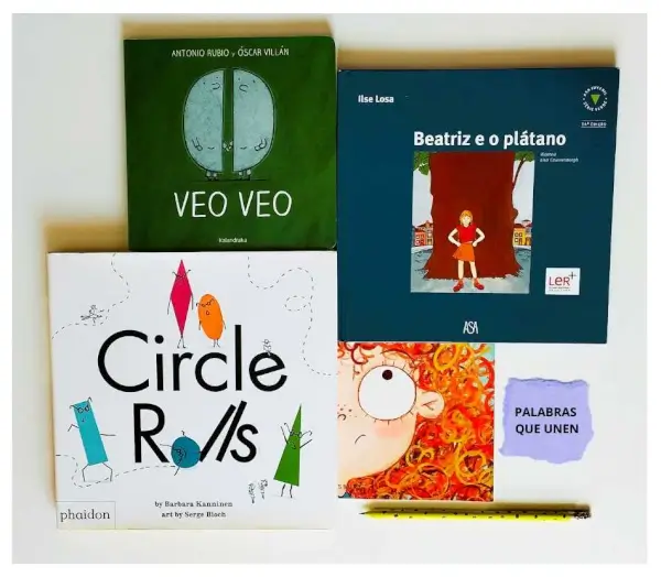 Niños y niñas de 6 a 12 años participando en un taller de traducción, rodeados de libros ilustrados y herramientas de escritura.